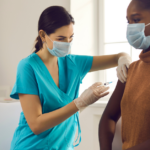 doctor giving a covid-19 vaccine to a patient